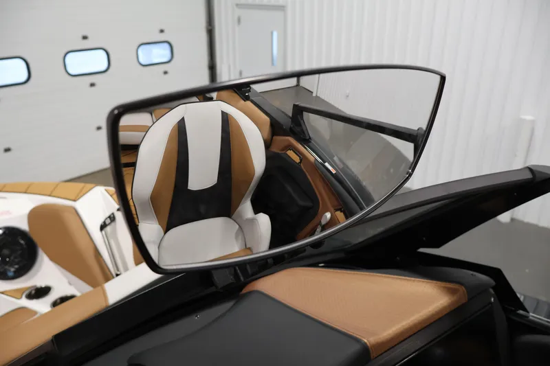 Slide: The Image of Rearview mirror reflecting interior of 2026 Centurion Fe22 boat with tan and white seating. - 15