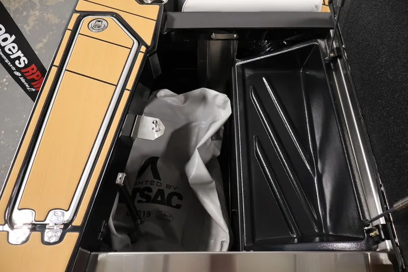 Slide: The Image of 2026 Centurion Fe22 boat storage compartment with black and tan interior detailing. - 40