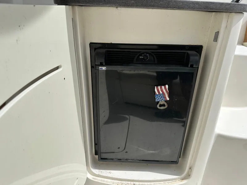 Slide: The Image of Built-in mini fridge on 2012 Sea Ray SLX 270 boat with American flag magnet. - 11