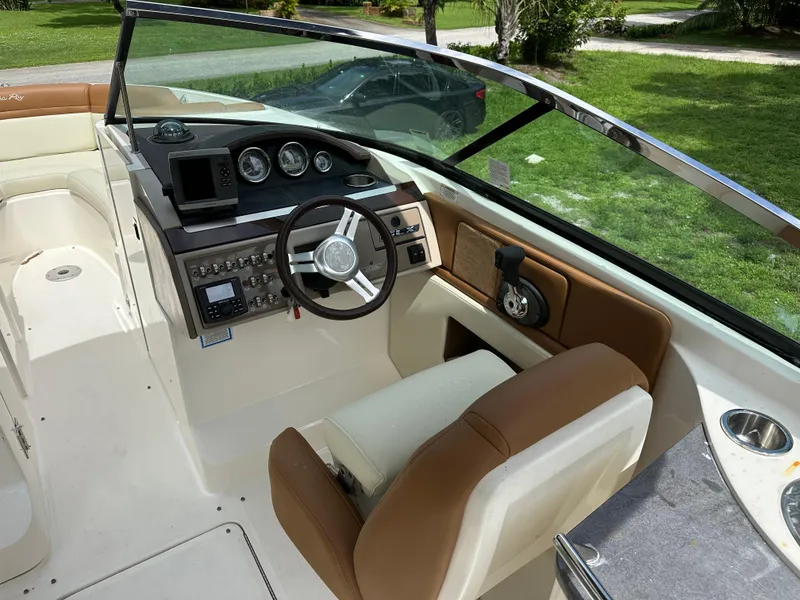 Slide: The Image of 2012 Sea Ray SLX 270 boat interior with steering wheel and control panel. - 13