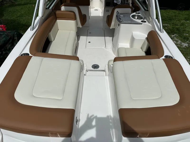 Slide: The Image of 2012 Sea Ray SLX 270 boat interior with white and brown seating. - 17