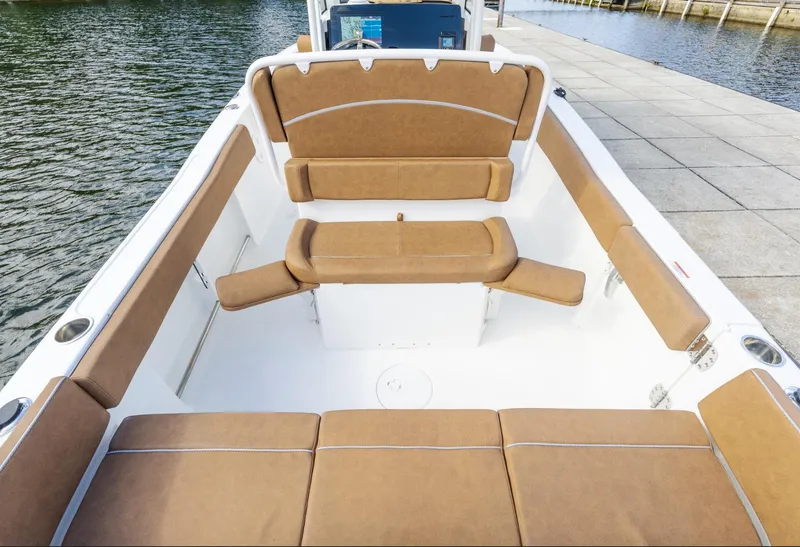 Slide: The Image of 2025 Sea Hunt Ultra 235 SE boat interior with tan seating, dockside view. - 14