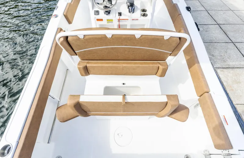 Slide: The Image of 2025 Sea Hunt Ultra 235 SE boat interior with tan seating and steering console. - 15