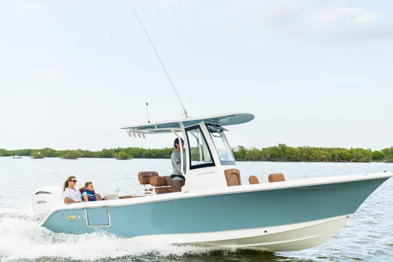 Slide: The Image of 2026 Sea Hunt Ultra 235 SE boat cruising on water with passengers enjoying the ride. - 20