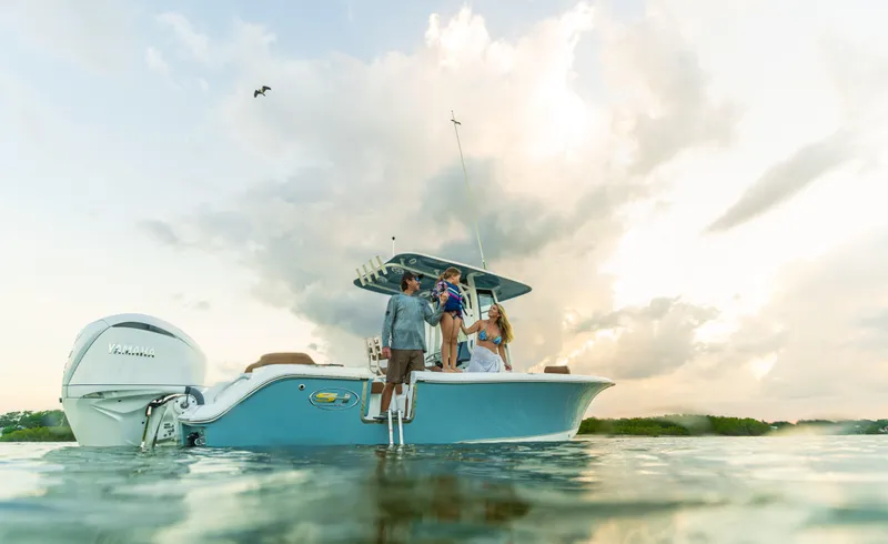 Slide: The Image of 2026 Sea Hunt Ultra 235 SE boat on water with people enjoying a scenic view. - 23