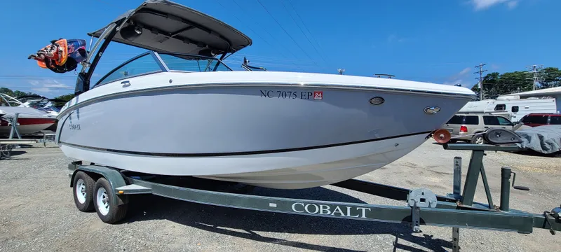 Slide: The Image of 2020 Cobalt R5 boat on trailer, parked outdoors under clear blue sky. - 0
