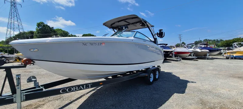 Slide: The Image of 2020 Cobalt R5 boat on trailer in sunny outdoor setting. - 1
