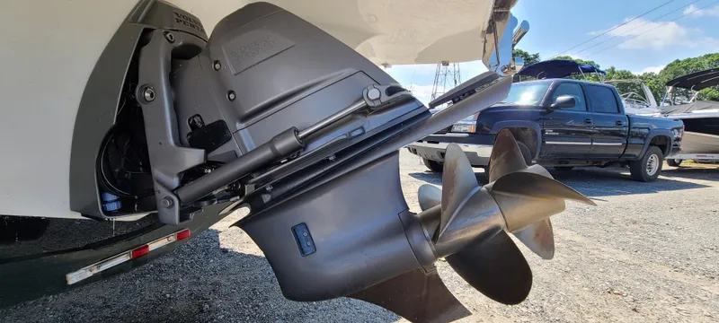 Slide: The Image of 2020 Cobalt R5 boat propeller and outdrive, parked near a black pickup truck. - 12