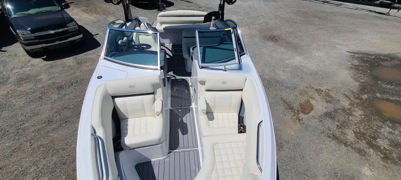 Slide: The Image of 2020 Cobalt R5 boat with white seating and sleek design, parked on gravel. - 13