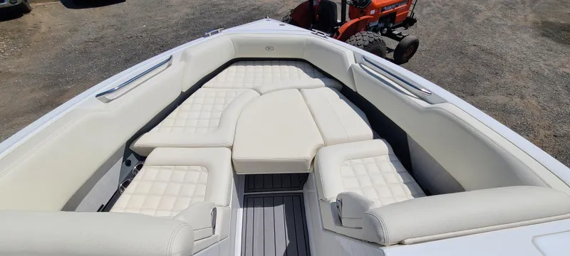 Slide: The Image of 2020 Cobalt R5 boat interior with white cushioned seating and gray flooring. - 15