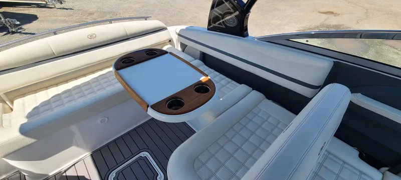 Slide: The Image of 2020 Cobalt R5 boat interior with cushioned seating and a central table. - 19