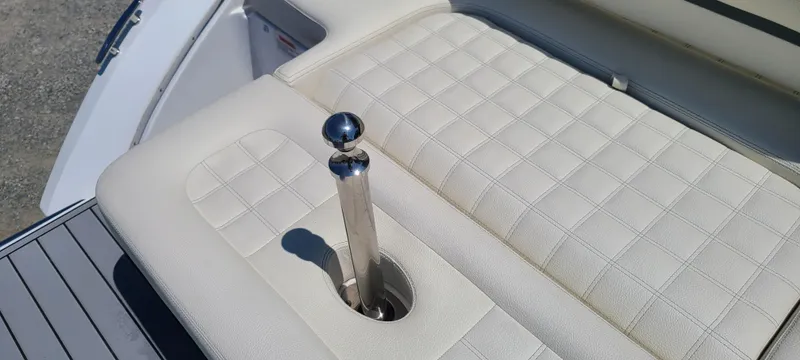 Slide: The Image of 2020 Cobalt R5 boat interior with beige quilted seating and chrome handle. - 22