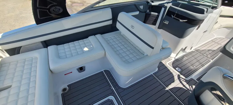 Slide: The Image of 2020 Cobalt R5 boat interior with white cushioned seating and sleek design. - 23