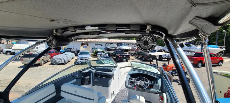 Slide: The Image of Interior view of a 2020 Cobalt R5 boat with speakers and parked vehicles outside. - 27