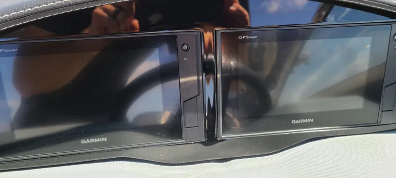 Slide: The Image of Dual Garmin displays on a 2020 Cobalt R5 dashboard, reflecting sunlight. - 32