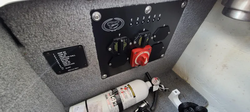 Slide: The Image of Control panel and fire extinguisher inside a 2020 Cobalt R5 boat. - 36