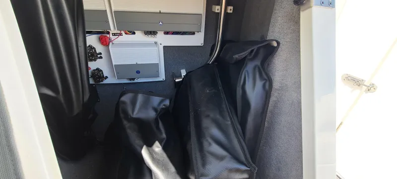 Slide: The Image of Interior storage compartment of a 2020 Cobalt R5 boat, featuring black bags and equipment. - 41
