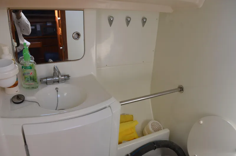 Slide: The Image of Bathroom interior of 1993 Beneteau Oceanis 370 yacht with sink, mirror, and toiletries. - 15