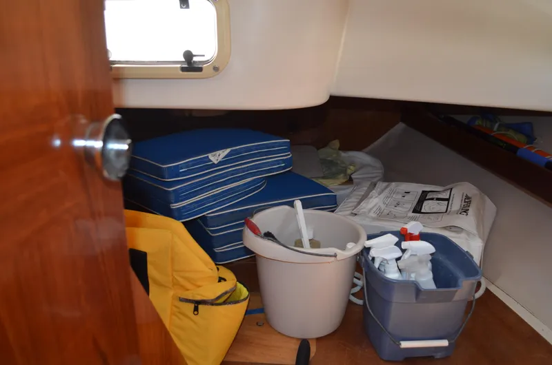 Slide: The Image of Interior of 1993 Beneteau Oceanis 370 sailboat with cleaning supplies and cushions. - 17