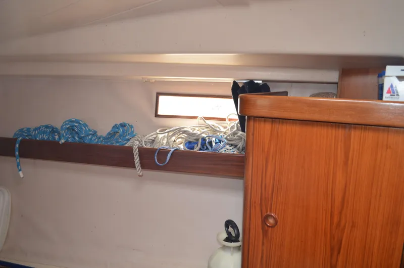 Slide: The Image of Interior of 1993 Beneteau Oceanis 370 sailboat with ropes and wooden cabinet. - 20
