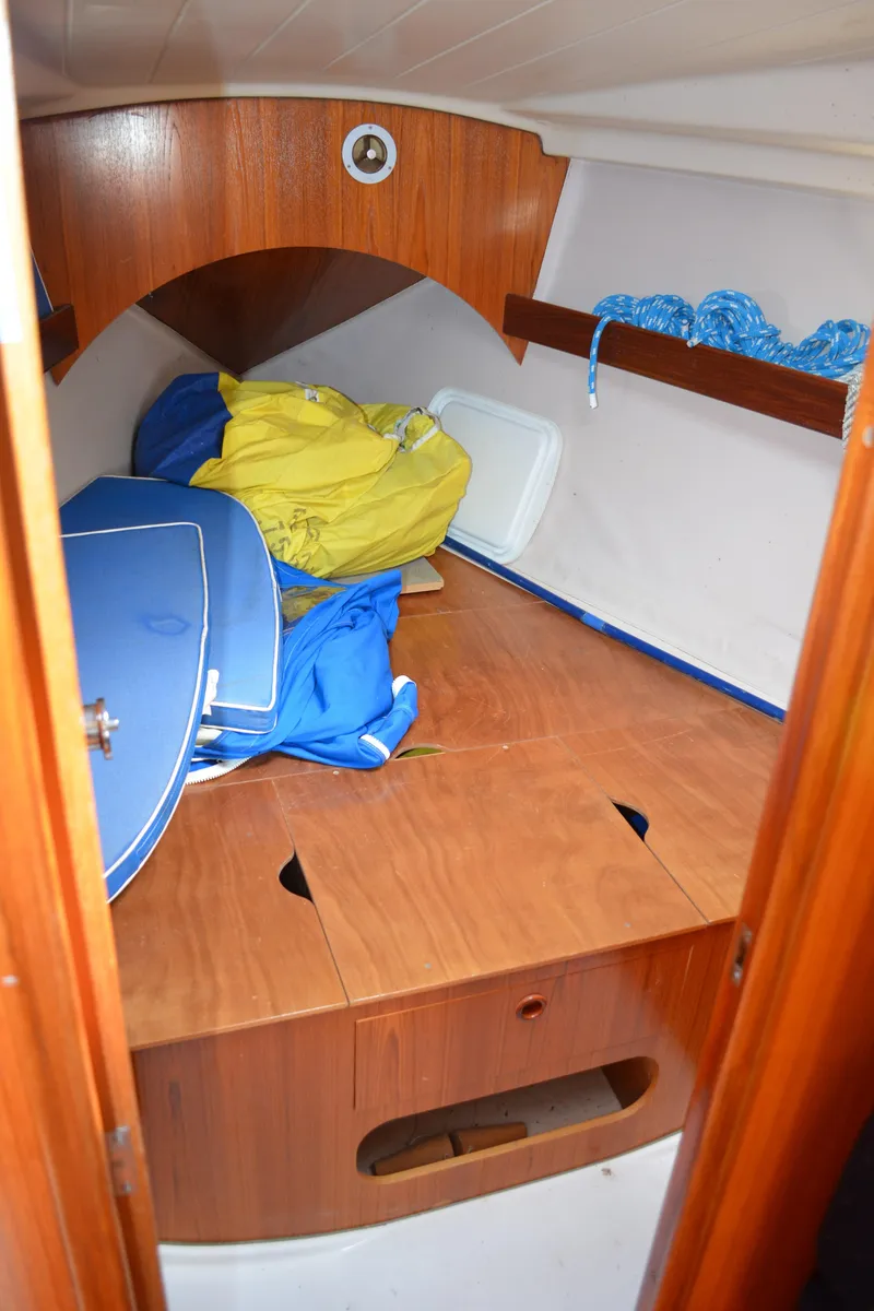 Slide: The Image of 1993 Beneteau Oceanis 370 cabin interior with storage and colorful gear. - 22