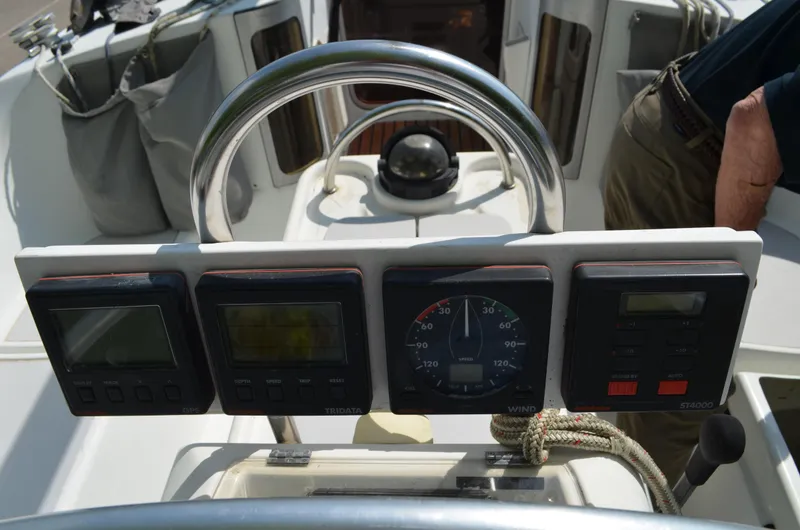 Slide: The Image of Cockpit instruments of a 1993 Beneteau Oceanis 370 sailboat, featuring navigation and control panels. - 3