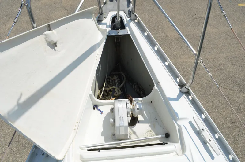 Slide: The Image of Bow storage compartment of a 1993 Beneteau Oceanis 370 sailboat, featuring anchor and winch. - 5