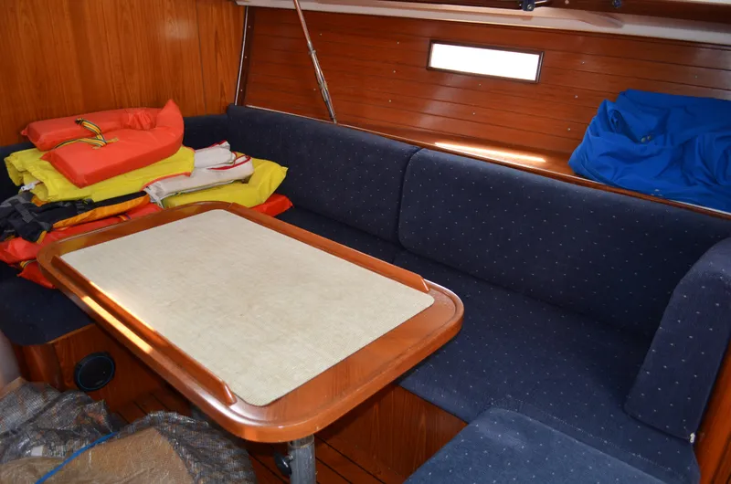 Slide: The Image of Interior of 1993 Beneteau Oceanis 370 sailboat with cozy seating and table. - 8