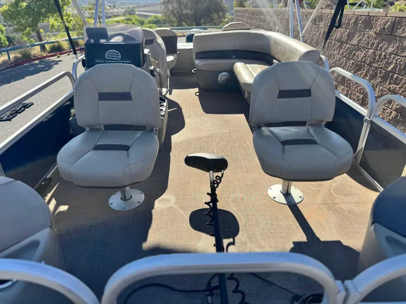 Slide: The Image of 2023 Sun Tracker Bass Buggy 18 DLX interior with seating and steering console. - 10