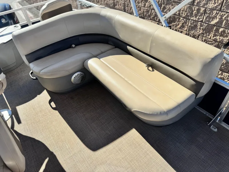 Slide: The Image of 2023 Sun Tracker Bass Buggy 18 DLX pontoon boat seating area with beige upholstery. - 16