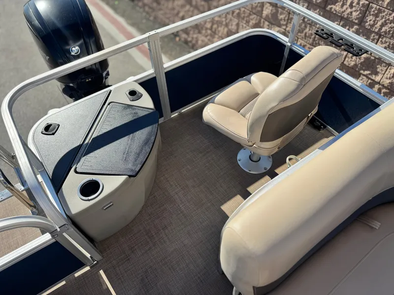 Slide: The Image of 2023 Sun Tracker Bass Buggy 18 DLX interior with seating and motor, showcasing modern design. - 18