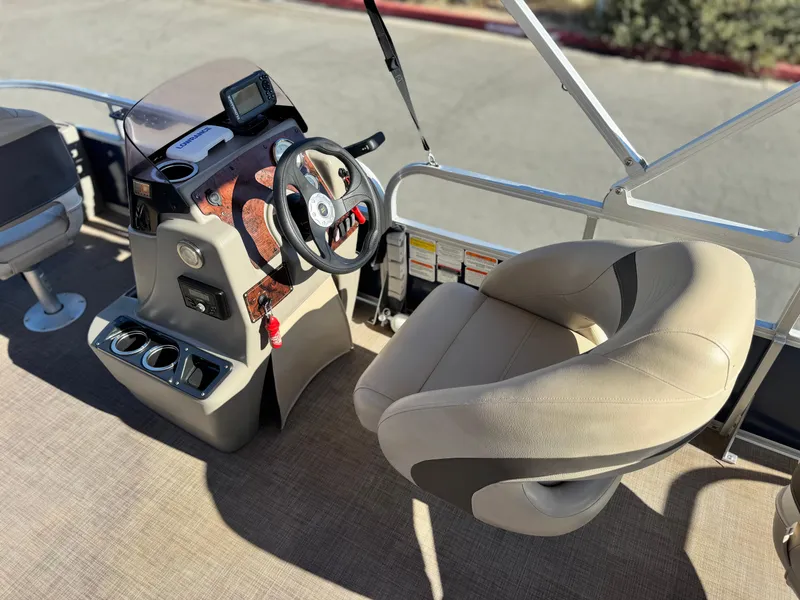 Slide: The Image of 2023 Sun Tracker Bass Buggy 18 DLX boat interior with steering console and seating. - 21