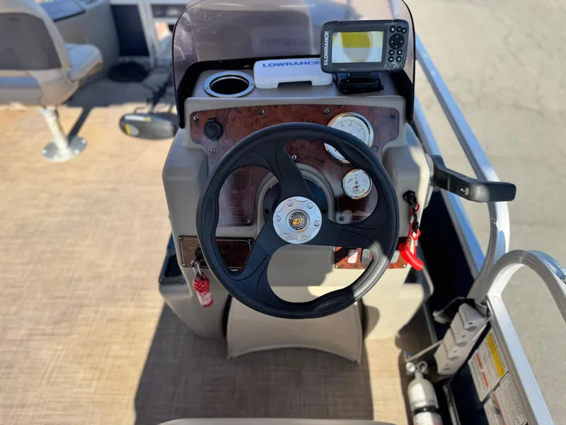 Slide: The Image of Steering console of 2023 Sun Tracker Bass Buggy 18 DLX with Lowrance fish finder. - 22