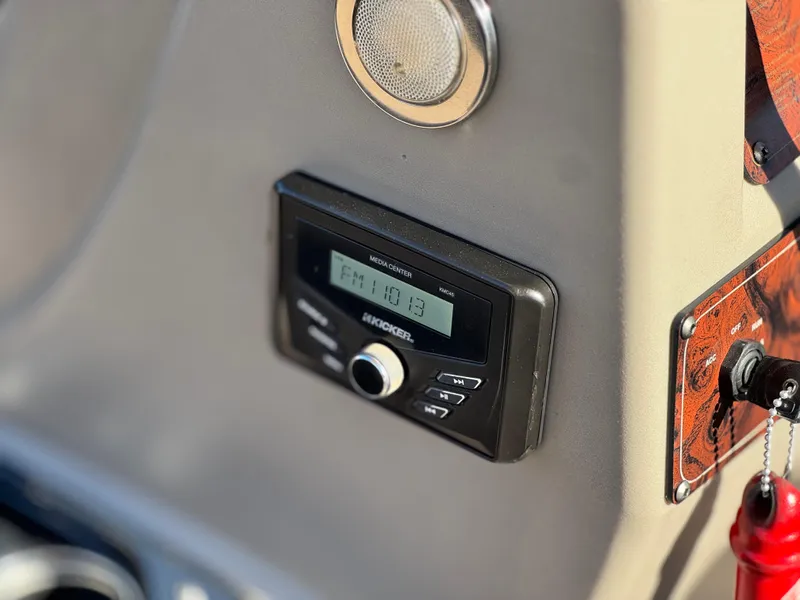 Slide: The Image of 2023 Sun Tracker Bass Buggy 18 DLX dashboard with Kicker media center and speaker. - 24