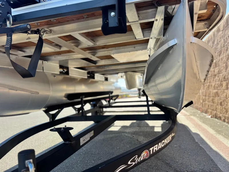 Slide: The Image of 2023 Sun Tracker Bass Buggy 18 DLX pontoon boat on trailer, underside view. - 4