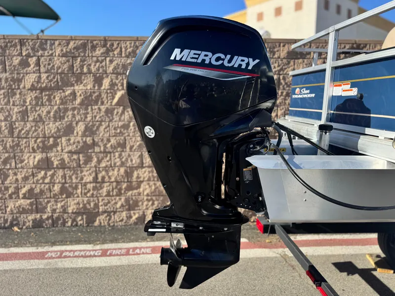 Slide: The Image of 2023 Sun Tracker Bass Buggy 18 DLX with Mercury outboard motor, parked outdoors. - 7