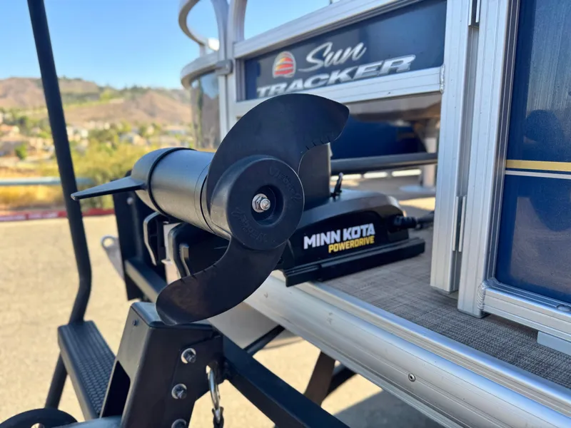 Slide: The Image of 2023 Sun Tracker Bass Buggy 18 DLX with Minn Kota PowerDrive motor, outdoor setting. - 8