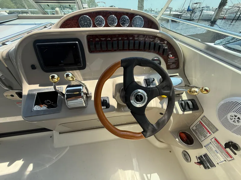 Slide: The Image of 2006 Sea Ray 290 Amberjack helm with steering wheel, controls, and gauges. - 10