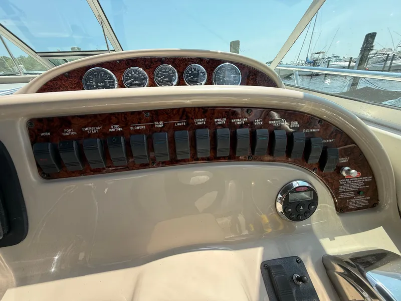 Slide: The Image of Control panel of a 2006 Sea Ray 290 Amberjack boat with switches and gauges. - 13