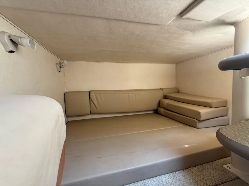 Slide: The Image of Interior cabin of 2006 Sea Ray 290 Amberjack with beige cushions and compact design. - 24