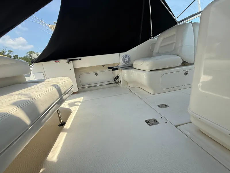 Slide: The Image of 2006 Sea Ray 290 Amberjack boat interior with white seating and black canopy. - 7