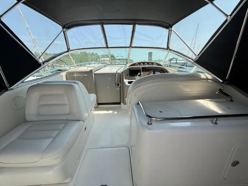 Slide: The Image of 2006 Sea Ray 290 Amberjack boat interior with white seating and helm. - 9