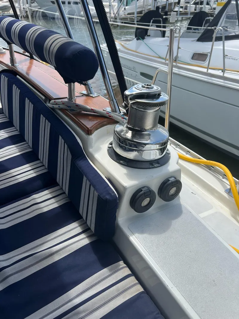 Slide: The Image of Striped cushions and winch on 1992 Endeavour 45 sailboat deck at marina. - 10