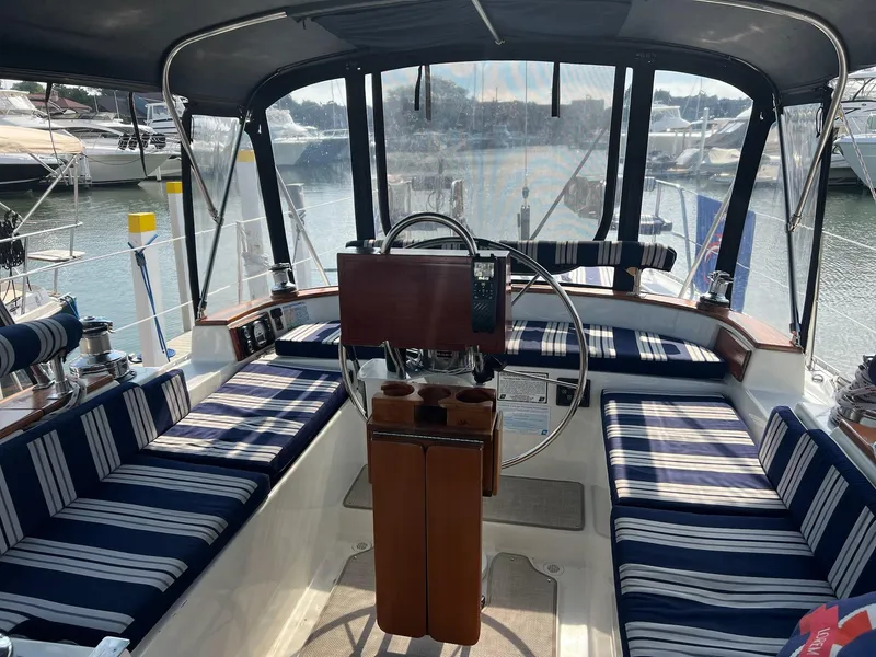 Slide: The Image of Interior view of 1992 Endeavour 45 sailboat cockpit with striped seating and steering wheel. - 11