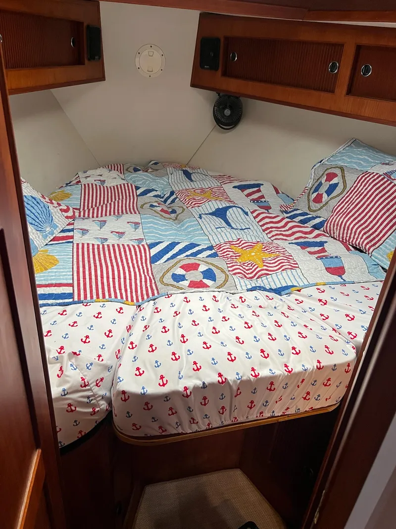 Slide: The Image of Cozy cabin bed in 1992 Endeavour 45 sailboat with nautical-themed bedding. - 15