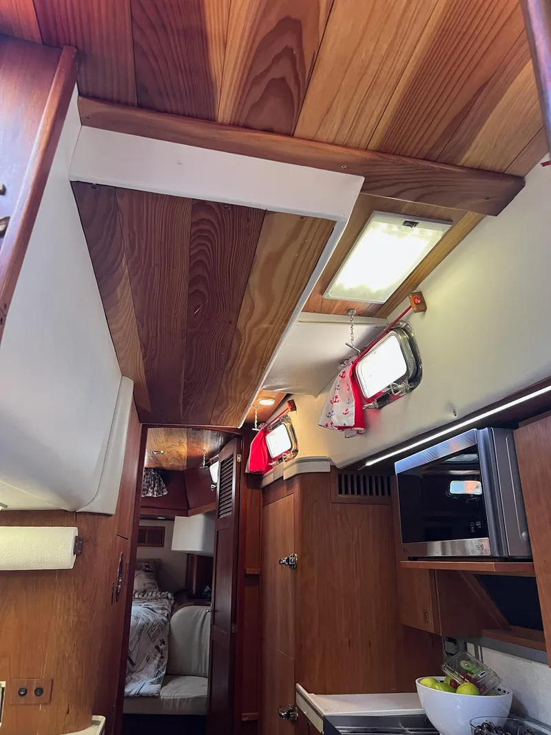 Slide: The Image of Interior of 1992 Endeavour 45 sailboat with wood paneling and modern amenities. - 17
