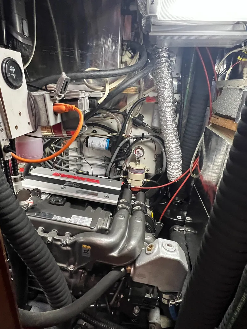 Slide: The Image of Engine room of a 1992 Endeavour 45 sailboat, showcasing mechanical components and wiring. - 34