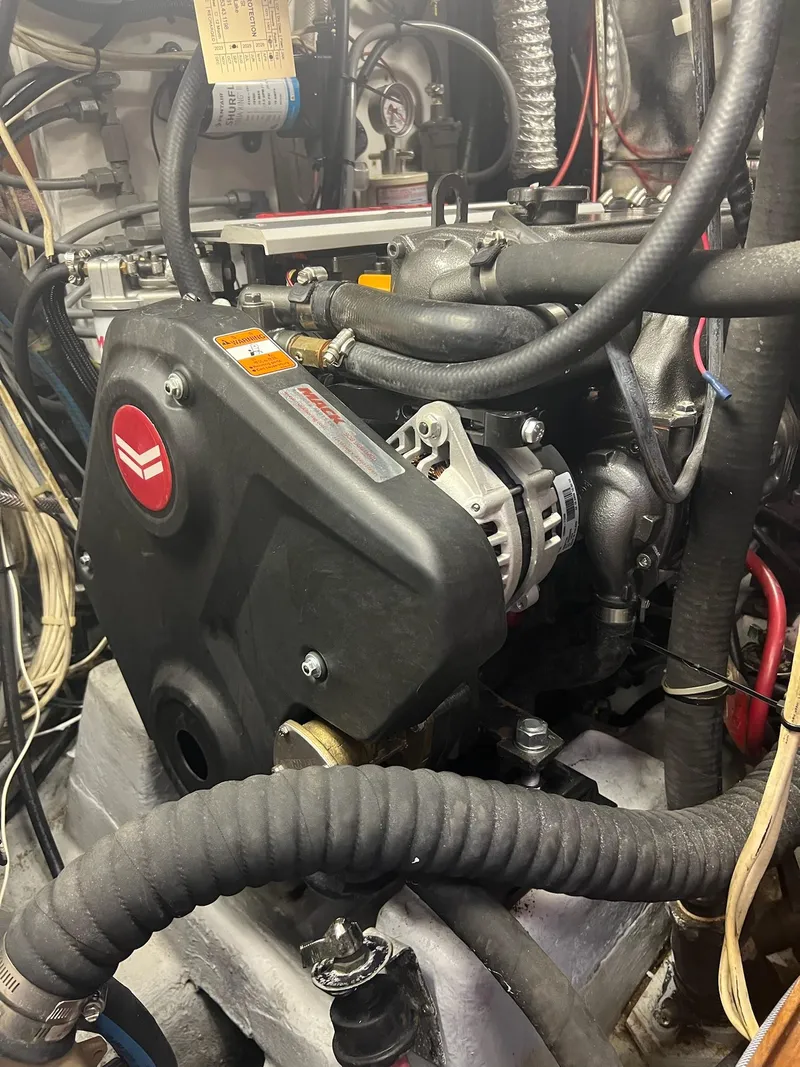 Slide: The Image of Engine compartment of a 1992 Endeavour 45 sailboat, showcasing mechanical components and wiring. - 38