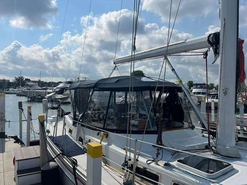 Slide: The Image of Sailboat Endeavour 45, 1992 model, docked at marina under a partly cloudy sky. - 4