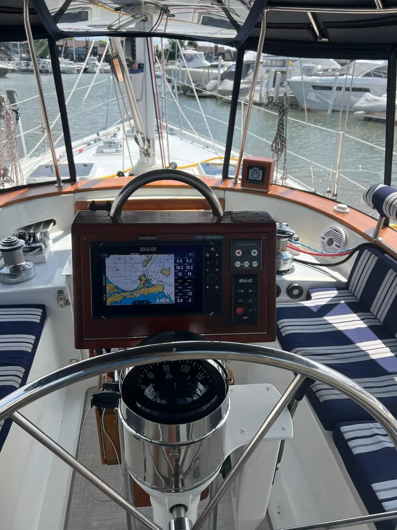 Slide: The Image of Cockpit of 1992 Endeavour 45 sailboat with navigation equipment and striped seating. - 6